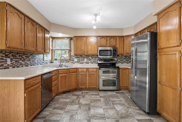 4127 Harwood Dr NE, Cedar Rapids, IA 52411 - kitchen featuring appliances with stainless steel finishes, brown cabinets, light countertops, and backsplash