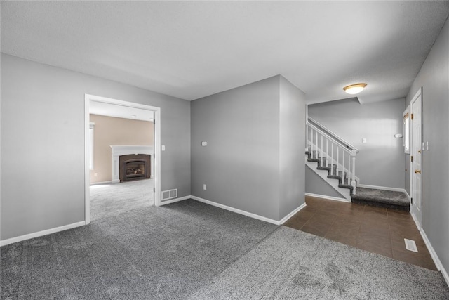 4127 Harwood Dr NE, Cedar Rapids, IA 52411 - tiled empty room with carpet floors and stairway