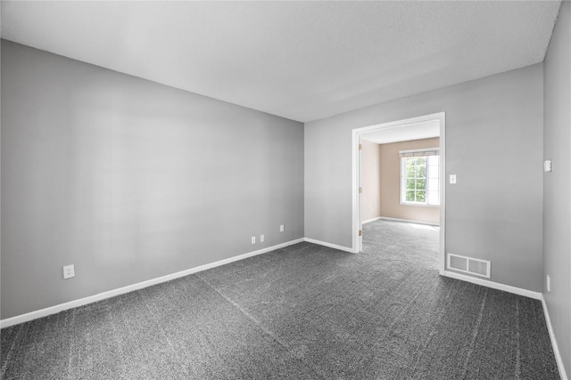 4127 Harwood Dr NE, Cedar Rapids, IA 52411 - spare room with dark colored carpet and baseboards