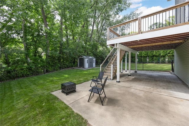 4127 Harwood Dr NE, Cedar Rapids, IA 52411 - view of patio featuring stairway, a storage shed, a deck, and a fire pit