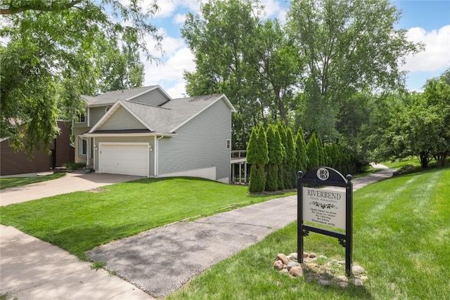 4127 Harwood Dr NE, Cedar Rapids, IA 52411 - traditional-style home with concrete driveway, a garage, a front lawn, and roof with shingles