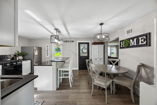 518 Main St, Fairfax, IA 52228 - dining area with light wood-style floors and a chandelier