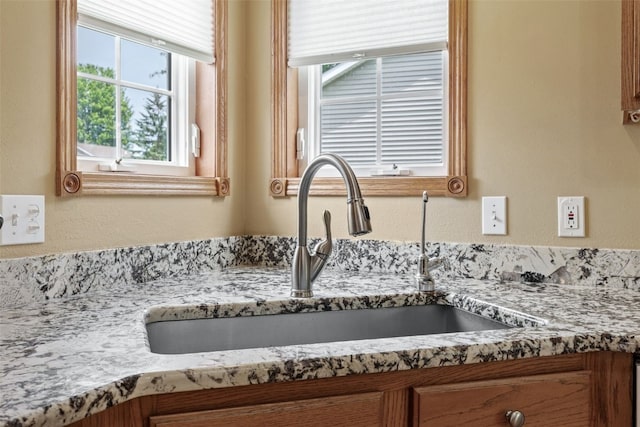 1865 Rock Island Dr, Ely, IA 52227 - kitchen view of brown cabinetry and light stone counters
