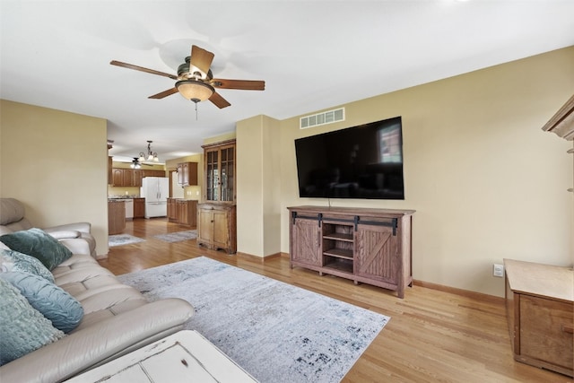 1865 Rock Island Dr, Ely, IA 52227 - living area with ceiling fan, light wood finished floors, and a chandelier