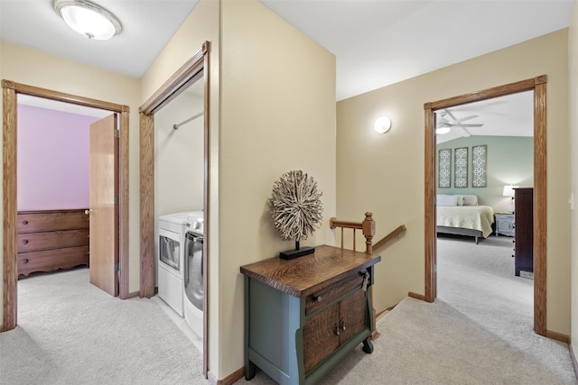 1865 Rock Island Dr, Ely, IA 52227 - hallway featuring washer and dryer, light carpet, and vaulted ceiling