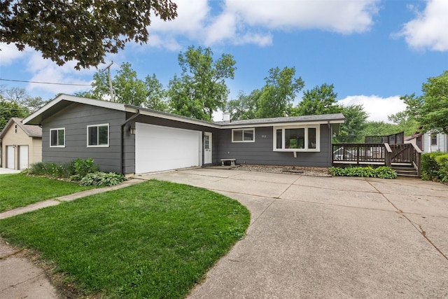 212 4th St SW, Mount Vernon, IA 52314 - single story home with a front lawn, a wooden deck, an attached garage, and concrete driveway