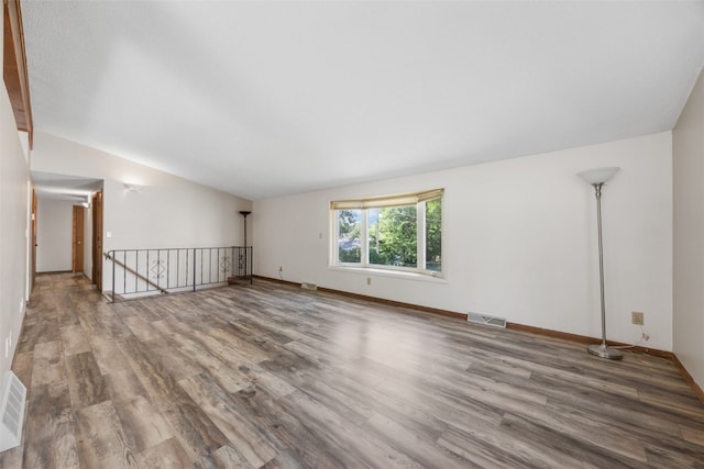 212 4th St SW, Mount Vernon, IA 52314 - spare room featuring vaulted ceiling and wood finished floors