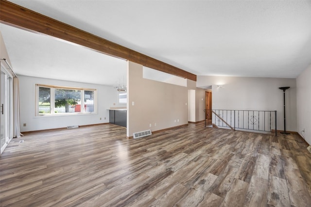 212 4th St SW, Mount Vernon, IA 52314 - unfurnished living room with wood finished floors and beamed ceiling