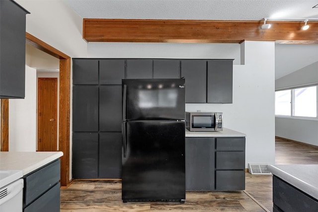 212 4th St SW, Mount Vernon, IA 52314 - kitchen featuring freestanding refrigerator, stainless steel microwave, gray cabinets, and track lighting