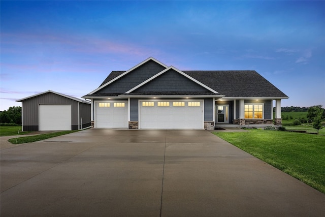 3363 Southridge Dr, Amana, IA 52203 - craftsman-style house featuring a lawn, stone siding, driveway, and a garage