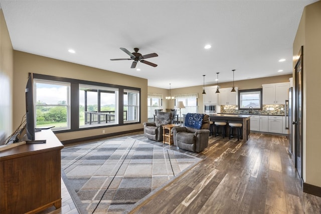 3363 Southridge Dr, Amana, IA 52203 - living room with dark wood-style flooring, a ceiling fan, and recessed lighting