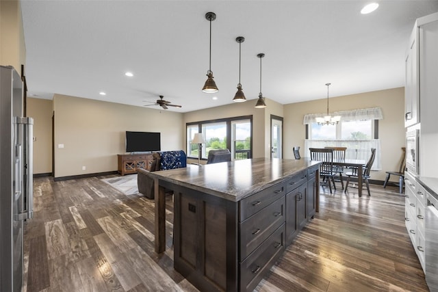 3363 Southridge Dr, Amana, IA 52203 - kitchen featuring dark wood-style flooring, a ceiling fan, white cabinetry, a kitchen island, and recessed lighting