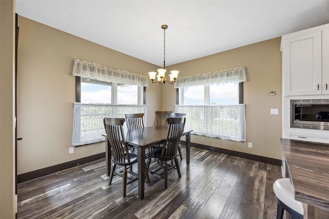 3363 Southridge Dr, Amana, IA 52203 - dining area featuring a chandelier and dark wood-type flooring