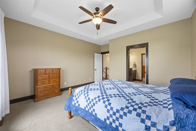 3363 Southridge Dr, Amana, IA 52203 - carpeted bedroom with a raised ceiling, a ceiling fan, and ensuite bath