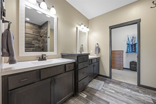 3363 Southridge Dr, Amana, IA 52203 - full bath with wood finished floors, two vanities, and a tile shower