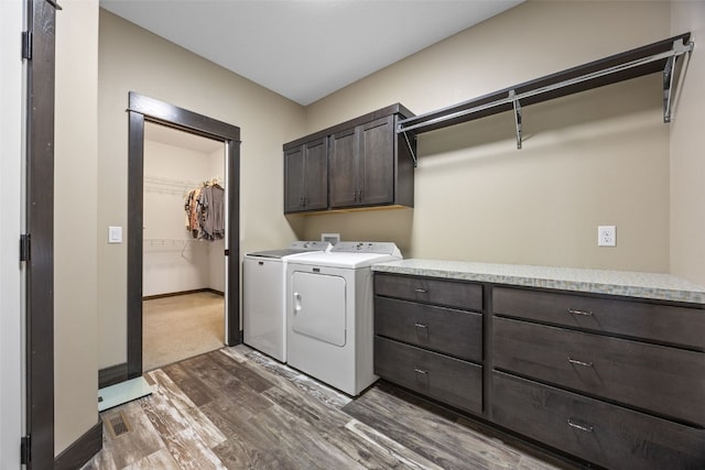 3363 Southridge Dr, Amana, IA 52203 - laundry room featuring cabinet space, dark wood-style flooring, and washing machine and dryer