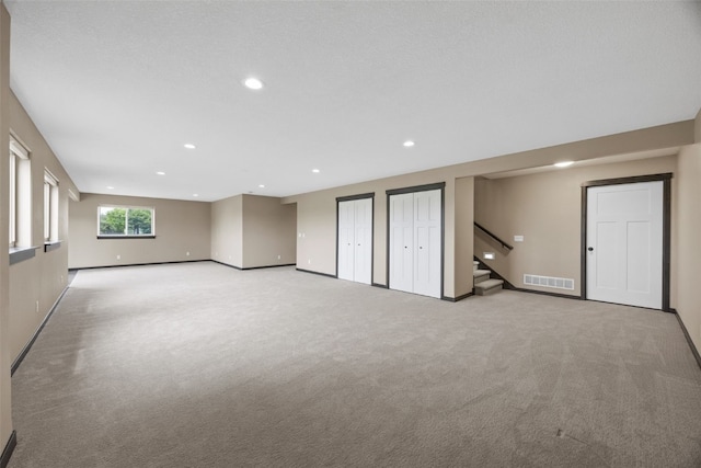 3363 Southridge Dr, Amana, IA 52203 - basement with recessed lighting, stairs, and light carpet