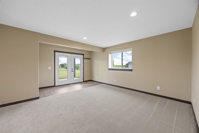 3363 Southridge Dr, Amana, IA 52203 - empty room featuring light colored carpet, recessed lighting, and french doors