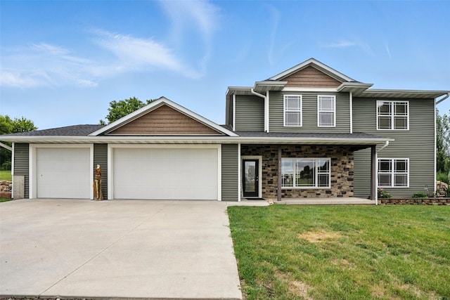 1102 S St, Urbana, IA 52345 - view of front of home with a garage, driveway, and a front lawn