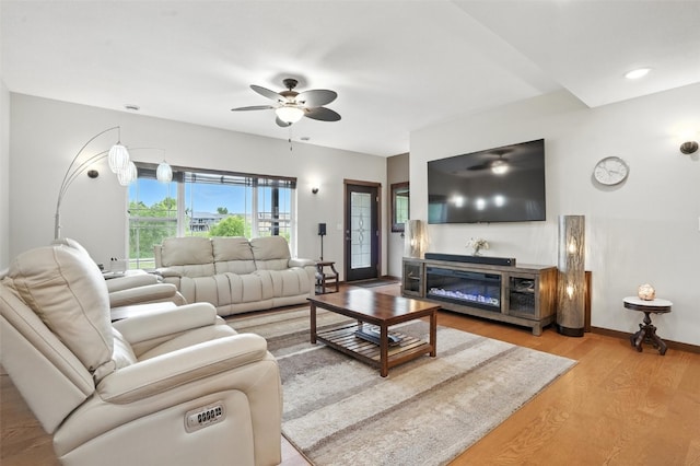 1102 S St, Urbana, IA 52345 - living area with a ceiling fan and light wood finished floors