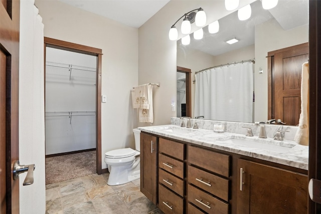 1102 S St, Urbana, IA 52345 - full bathroom with double vanity, a spacious closet, and stone finish flooring