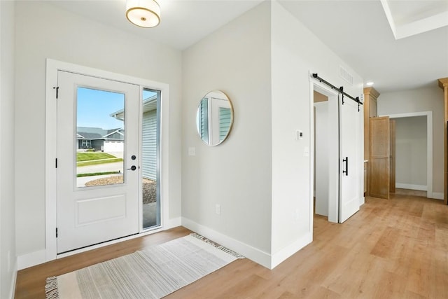 1002 Croell Ave, Tiffin, IA 52340 - entrance foyer featuring a barn door and light wood-style floors