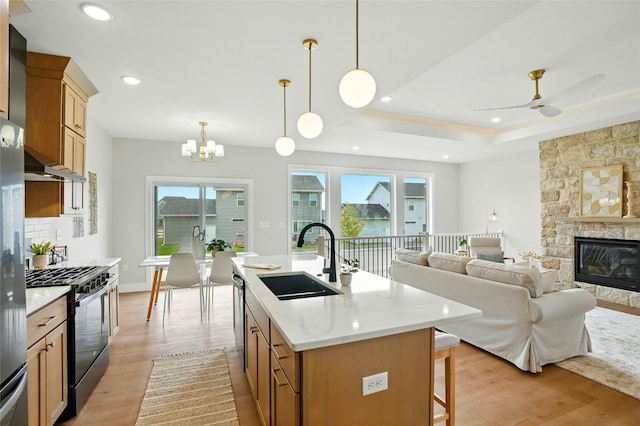 1002 Croell Ave, Tiffin, IA 52340 - kitchen with gas stove, plenty of natural light, light wood-style floors, a chandelier, and recessed lighting