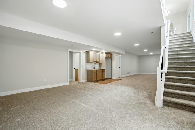 1002 Croell Ave, Tiffin, IA 52340 - unfurnished living room with light carpet, stairway, recessed lighting, and bar