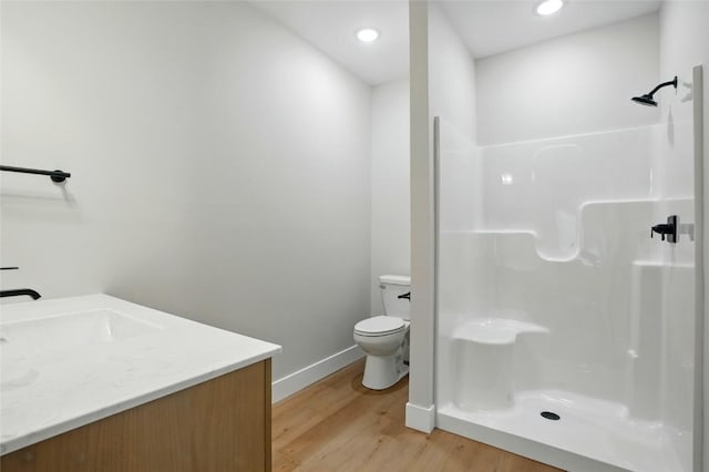1002 Croell Ave, Tiffin, IA 52340 - full bathroom with wood finished floors, vanity, a shower, and recessed lighting