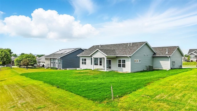 1002 Croell Ave, Tiffin, IA 52340 - back of house featuring a lawn, a patio area, and roof with shingles