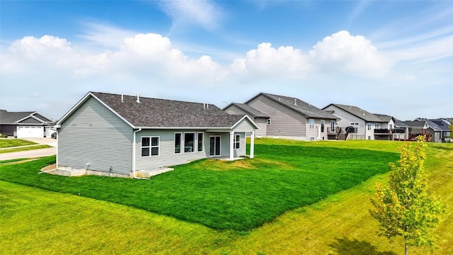 1002 Croell Ave, Tiffin, IA 52340 - rear view of property with a residential view, a lawn, and roof with shingles