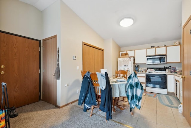 1230 Murray NE Unit 10, Cedar Rapids, IA 52402 - kitchen with white appliances, lofted ceiling, light countertops, white cabinets, and light tile patterned flooring