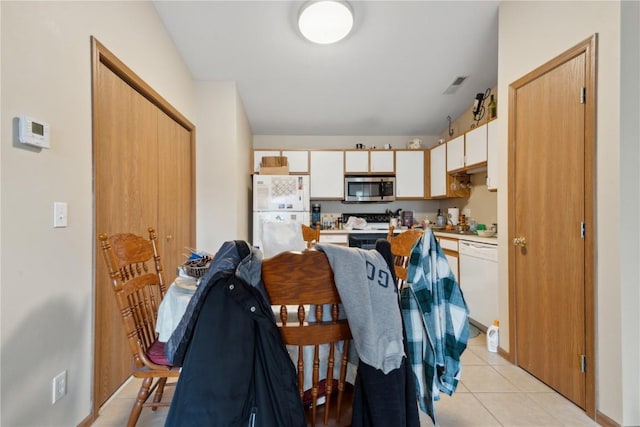 1230 Murray NE Unit 10, Cedar Rapids, IA 52402 - kitchen featuring white appliances, light countertops, white cabinetry, and light tile patterned floors