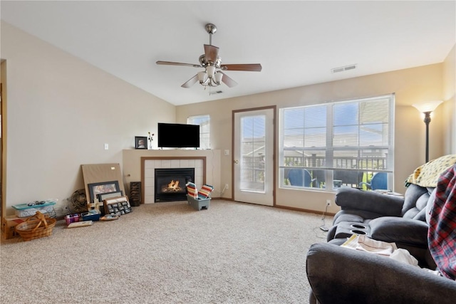 1230 Murray NE Unit 10, Cedar Rapids, IA 52402 - carpeted living room with a tile fireplace, a ceiling fan, plenty of natural light, and vaulted ceiling