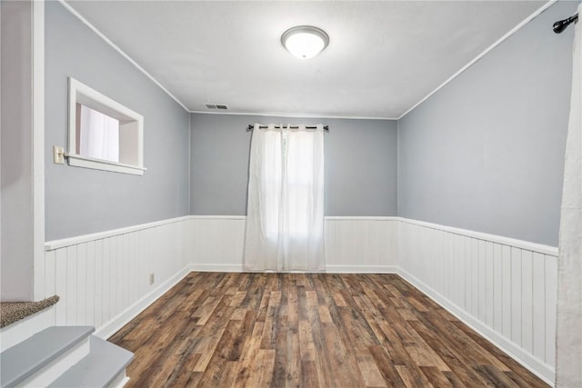 316 E Washington St, Center Point, IA 52213 - empty room with wainscoting, wood finished floors, and ornamental molding
