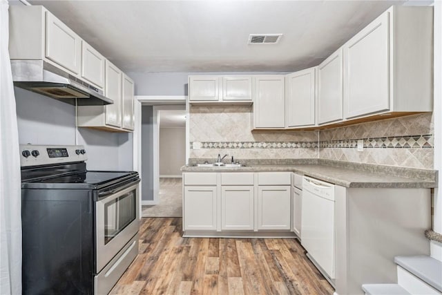 316 E Washington St, Center Point, IA 52213 - kitchen with electric range, dishwasher, under cabinet range hood, light wood-style floors, and white cabinetry