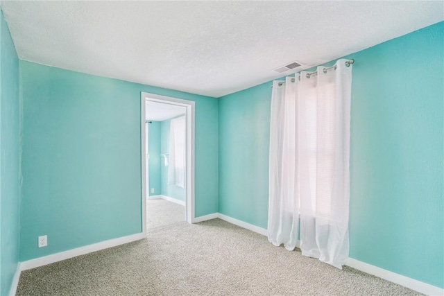 316 E Washington St, Center Point, IA 52213 - carpeted empty room featuring a textured ceiling and baseboards