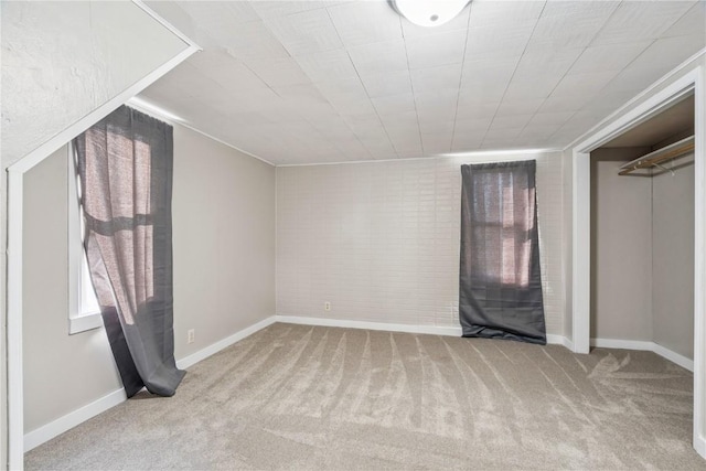 316 E Washington St, Center Point, IA 52213 - unfurnished bedroom featuring carpet floors and brick wall