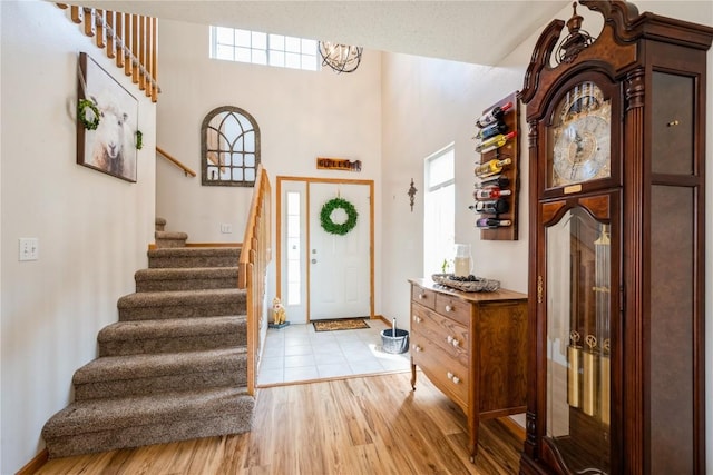 4593 Spoonbill Ct, Marion, IA 52302 - entrance foyer with stairs, light wood-style flooring, and a towering ceiling