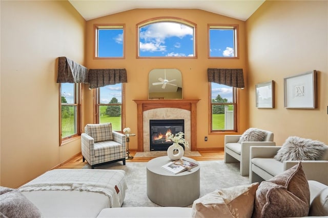 5515 W Mustang Rd NE, Cedar Rapids, IA 52411 - living area featuring wood finished floors, a fireplace, high vaulted ceiling, and a ceiling fan