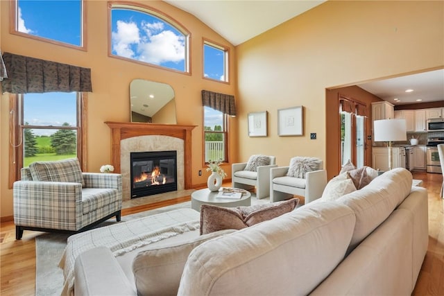 5515 W Mustang Rd NE, Cedar Rapids, IA 52411 - living area with light wood-style floors, a fireplace, and high vaulted ceiling