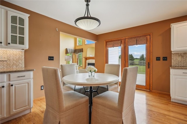 5515 W Mustang Rd NE, Cedar Rapids, IA 52411 - dining room featuring light wood-style floors and a tiled fireplace