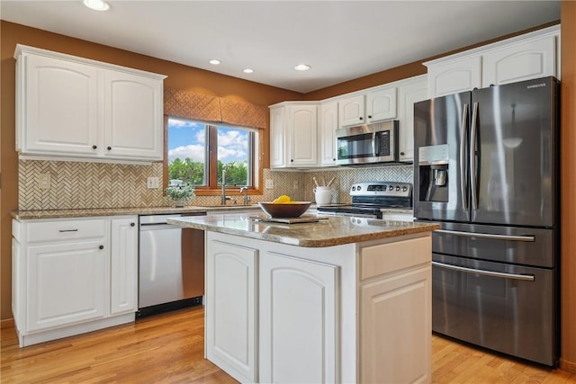5515 W Mustang Rd NE, Cedar Rapids, IA 52411 - kitchen featuring stainless steel appliances, light stone countertops, white cabinets, light wood-style floors, and recessed lighting