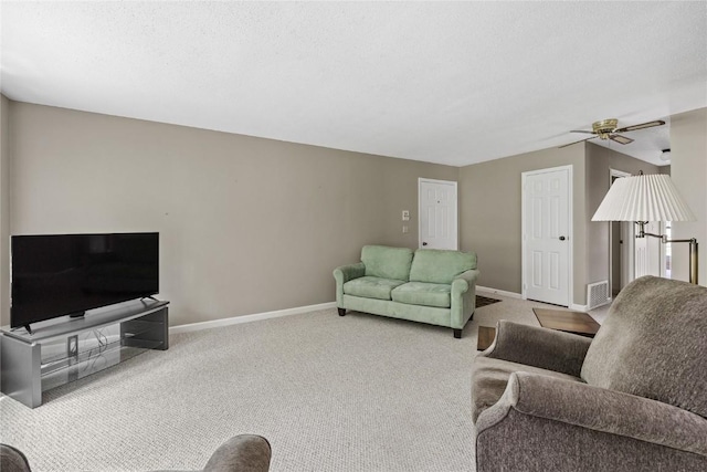 3921 Lexington Dr NE Unit B, Cedar Rapids, IA 52402 - carpeted living room featuring baseboards and ceiling fan