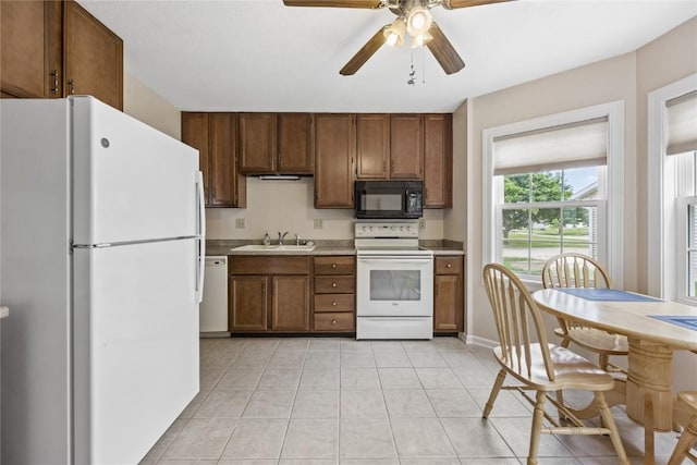 3921 Lexington Dr NE Unit B, Cedar Rapids, IA 52402 - kitchen with white appliances, a ceiling fan, light countertops, light tile patterned flooring, and brown cabinets