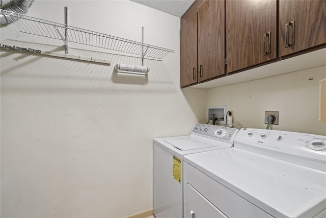 3921 Lexington Dr NE Unit B, Cedar Rapids, IA 52402 - laundry area featuring cabinet space, washer and dryer, and a textured ceiling