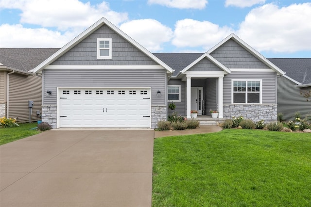 1953 Bowstring Dr, Marion, IA 52302 - craftsman house featuring stone siding, driveway, an attached garage, and a front yard