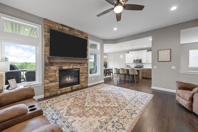 1953 Bowstring Dr, Marion, IA 52302 - living room featuring ceiling fan, dark wood-style flooring, plenty of natural light, recessed lighting, and a fireplace