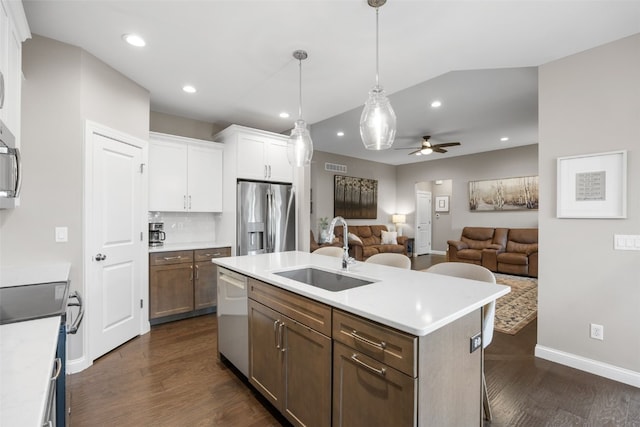 1953 Bowstring Dr, Marion, IA 52302 - kitchen with appliances with stainless steel finishes, dark wood finished floors, white cabinets, open floor plan, and a ceiling fan