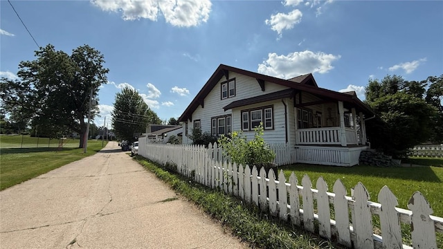 419 21st St NE, Cedar Rapids, IA 52402 - view of side of home with a porch and concrete driveway